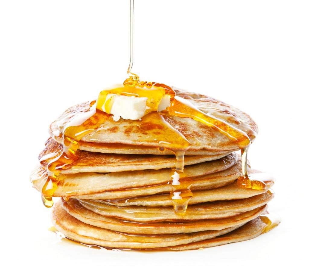 Stack+of+Small+pancakes+in+syrup+on+white+background