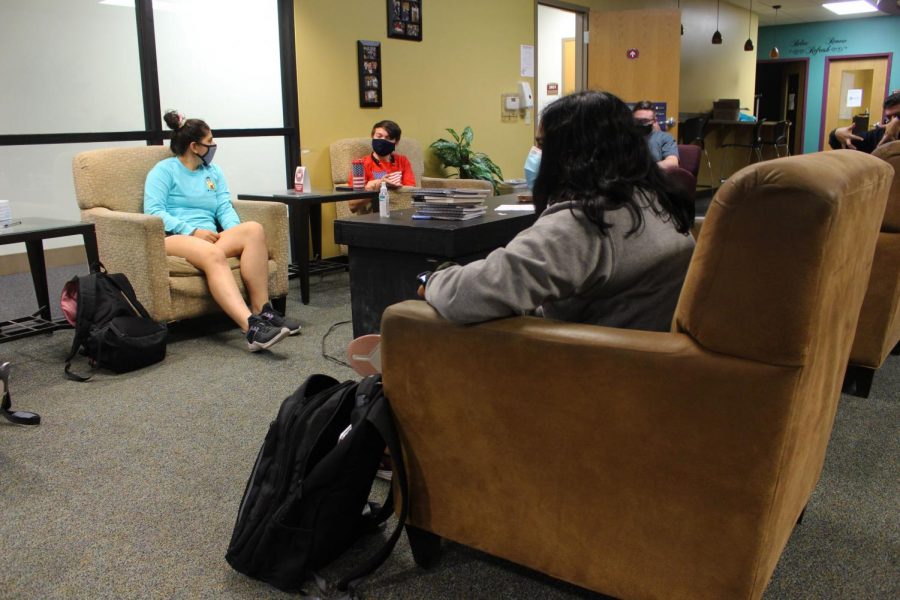 Sajita Elaprolu (front), Anna Ramalho (left) and Daniel Grabowski (center) sit in the commuter corner between classes, which has been greatly affected by the COVID-19 pandemic.