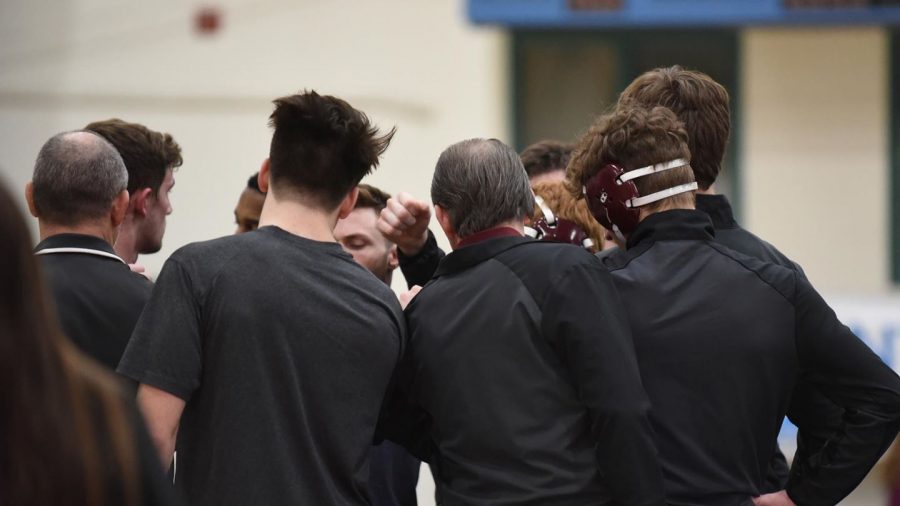 The Gannon University men’s wrestling coach, Don Henry, meets with his team before competing during the 2019-20 season. The Knights would finish with an overall reocrd of 8-6.
