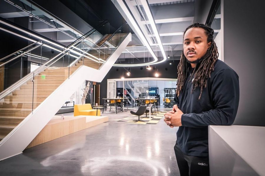 Graduate student Geremy Paige stands in the common area of the renovated I-HACK building. 