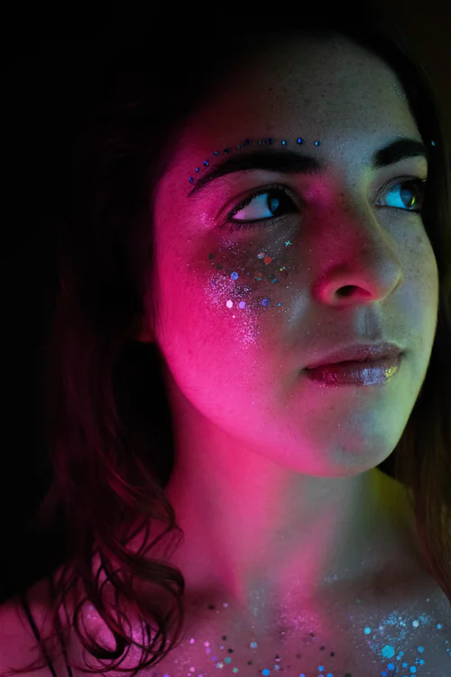UNSPLASH/Alexandra Lowenthan

Model poses under pink light with a ‘Euphoria’ inspired makeup look, as Rue and Jules often sport.