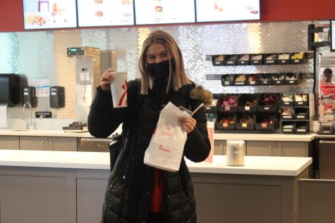 Gannon University sophomore Cassie Irwin gets ready to eat her first meal at the new Chick-fil-A that has just opened on the Erie campus.  
