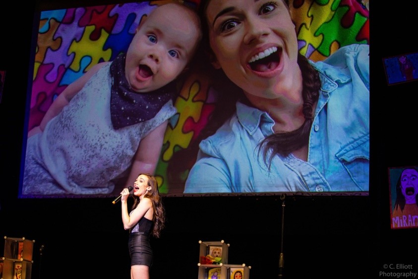 Colleen Ballinger pictured at a live show with photo of her first son, Flynn.