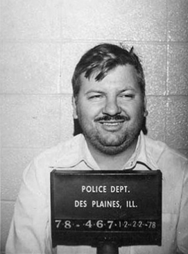 John Wayne Gacy poses for his mugshot with a smile, displaying just how cruel and sadistic he was regarding his crimes.