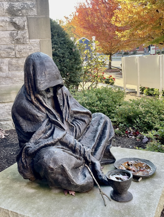 Near the entrance of the Cathedral of St. Paul sits a statue of a figure of a man dressed in a cloak with a cup and a plate filled with a mix of water and fallen leaves from the rainy fall days. The nail holes in his hands allow us to assume that the man is Jesus. Known as “Homeless Jesus” is a representation of faith but also social concerns such as homelessness that plague the Erie population.