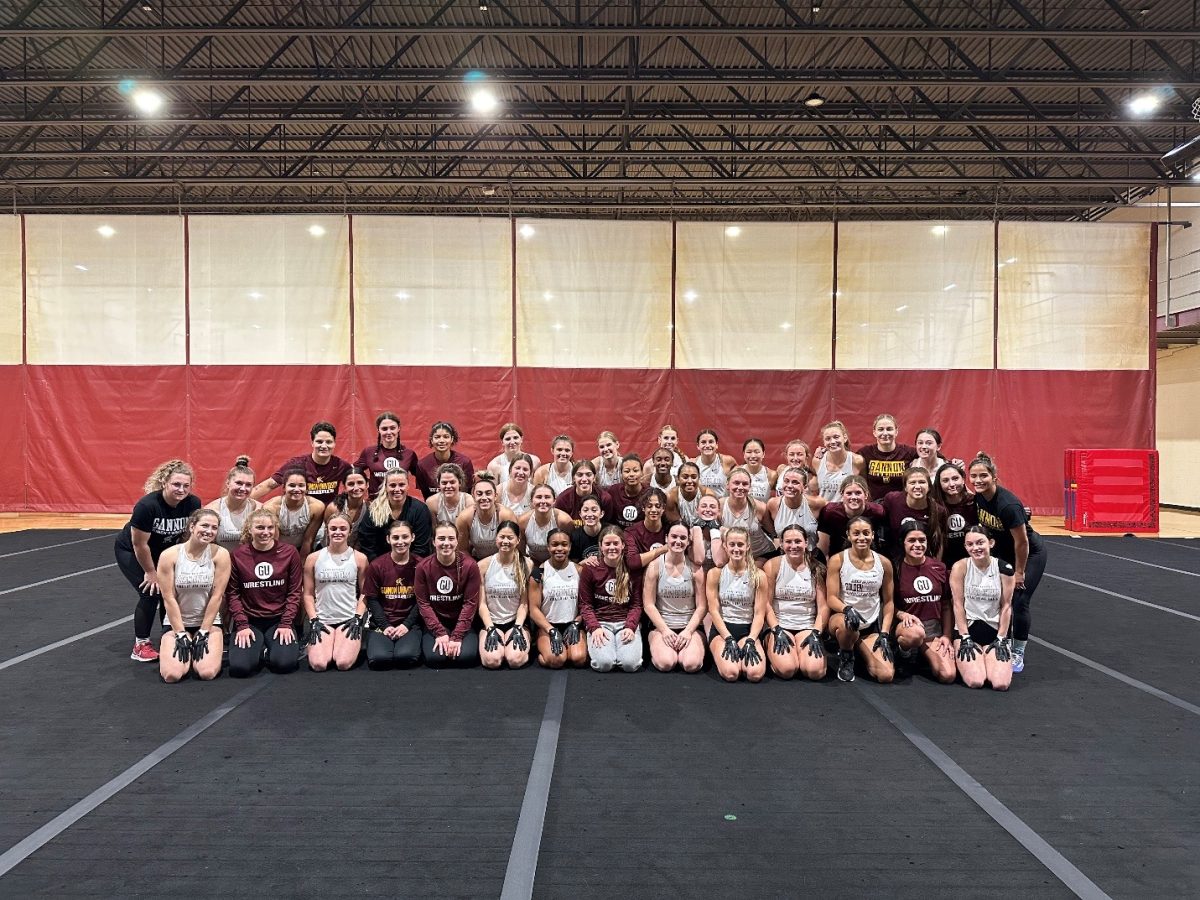 The Gannon Women’s wrestling team and Acrobatics and Tumbling team embrace after their sister sport activity. 