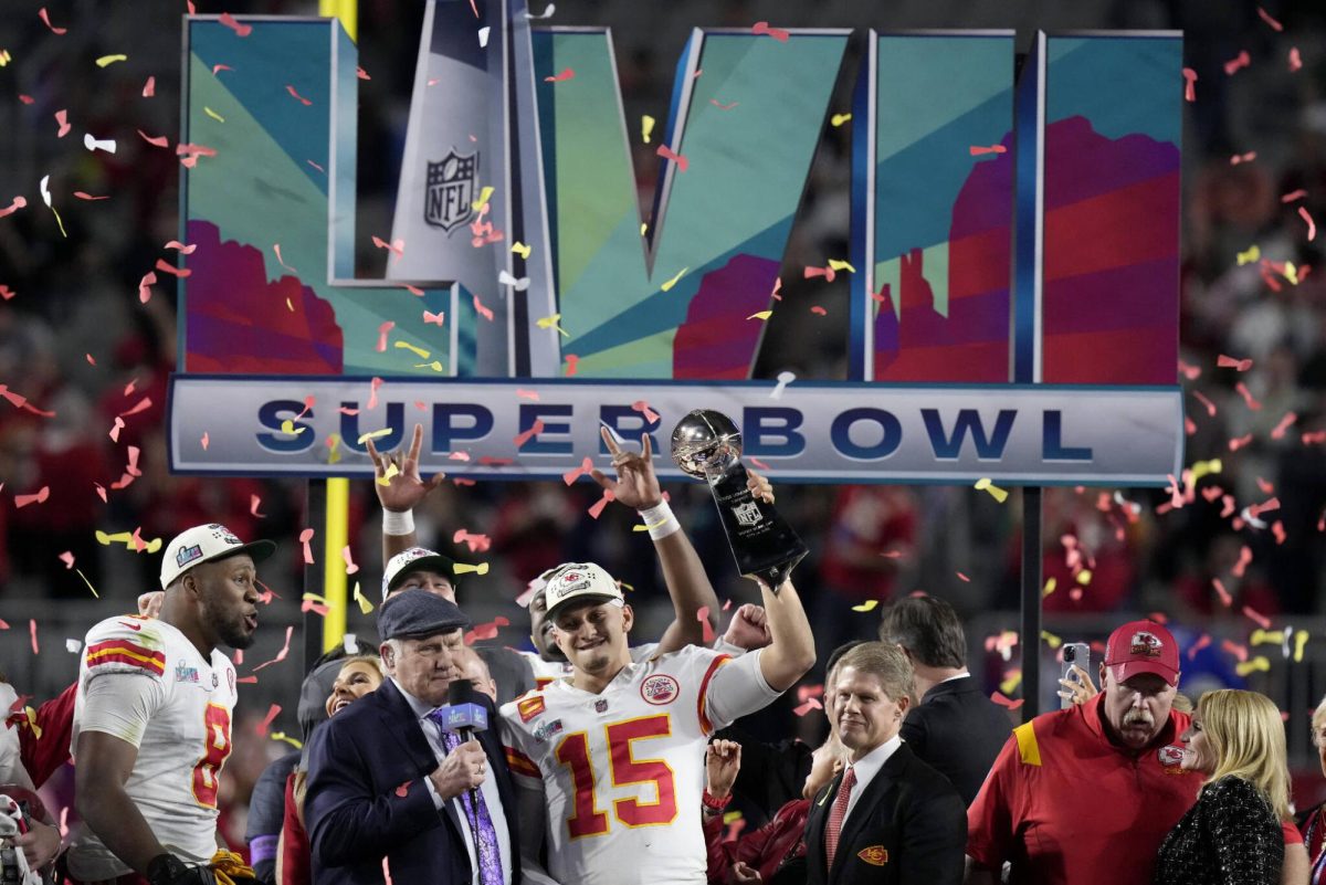 Kansas City Chiefs quarterback Patrick Mahomes (pictured) raises the Lombardi Trophy.