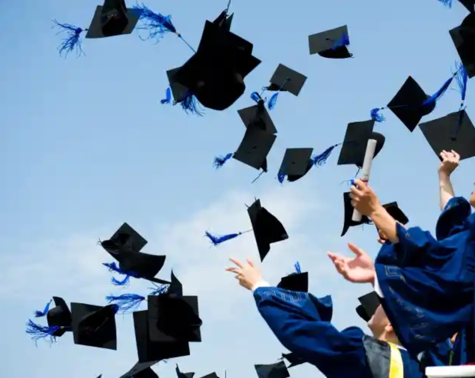 Photo depicts students throwing their caps into the air as a part of a graduation ceremony (Photo/College Candy)