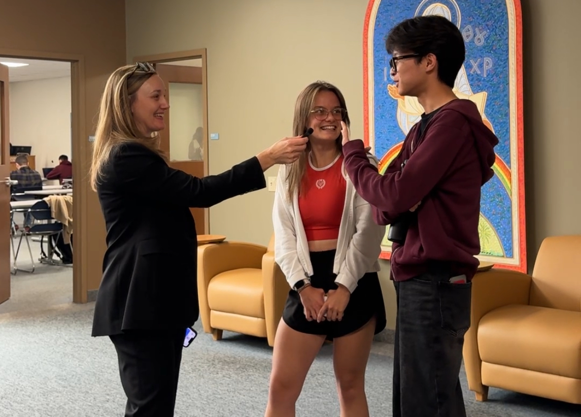 Pictured: Sarah Ewing, Ph.D. (left) interviews students Cadence Hoover (middle) and Khan Munkhsaikhan (right) about their planned Halloween costumes.